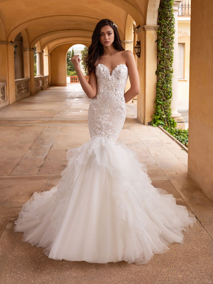 Mermaid dress with open back along with beaded appliques and a sweetheart neckline 