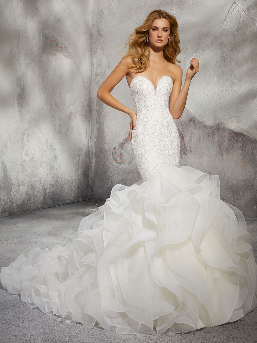 mermaid wedding dress with embroidered appliqués on the fitted bodice and covered back button