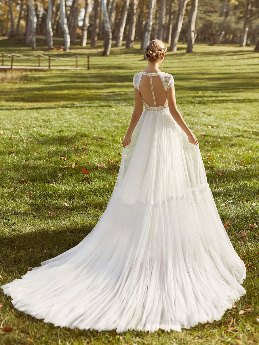 Elegant bridal gown with V-neckline and drop sleeves.